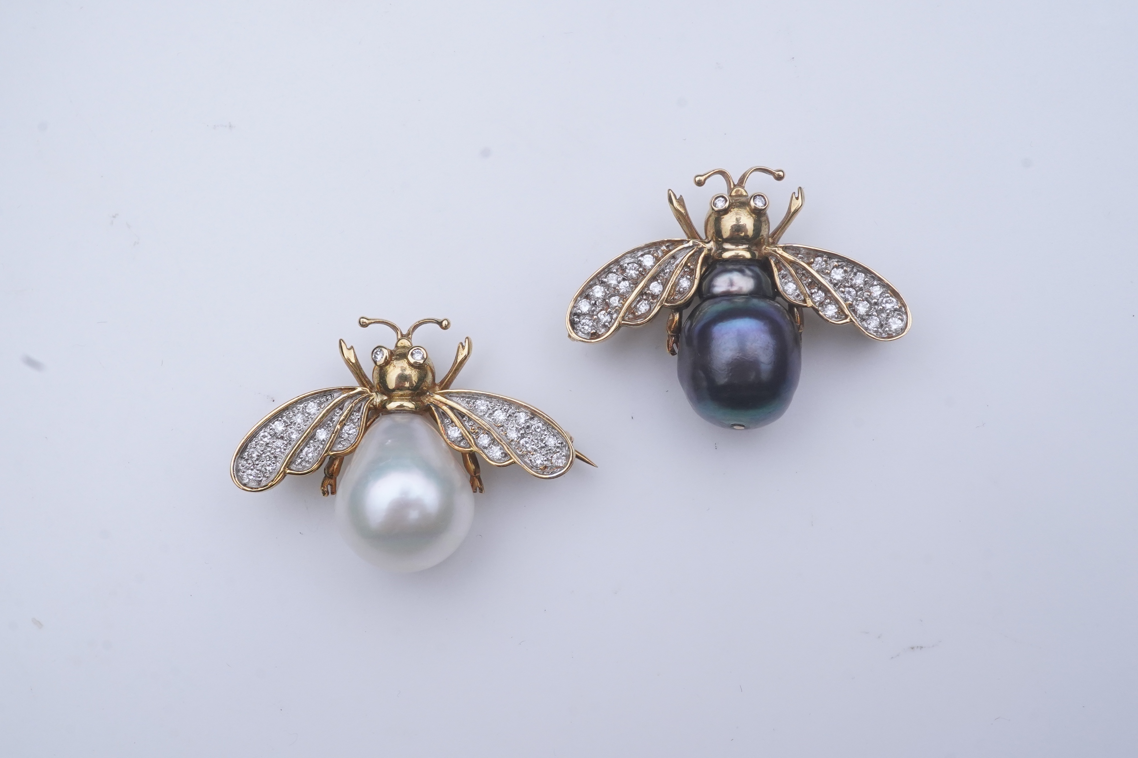 Deakin & Francis, a pair of 18ct gold, cultured pearl and diamond brooches